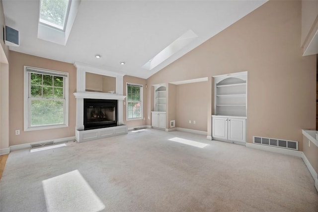10276 Rinaman Rd, Mccandless, PA 15090 - unfurnished living room with a skylight, baseboards, a glass covered fireplace, carpet, and high vaulted ceiling