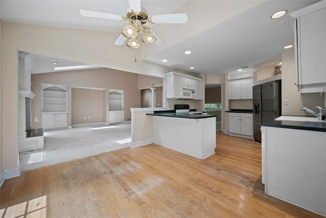 10276 Rinaman Rd, Mccandless, PA 15090 - kitchen with black fridge, white microwave, a ceiling fan, range with electric stovetop, and open floor plan