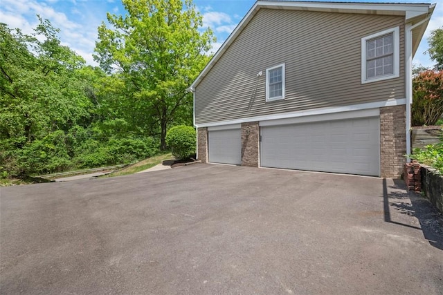 10276 Rinaman Rd, Mccandless, PA 15090 - view of side of property with asphalt driveway, brick siding, and an attached garage