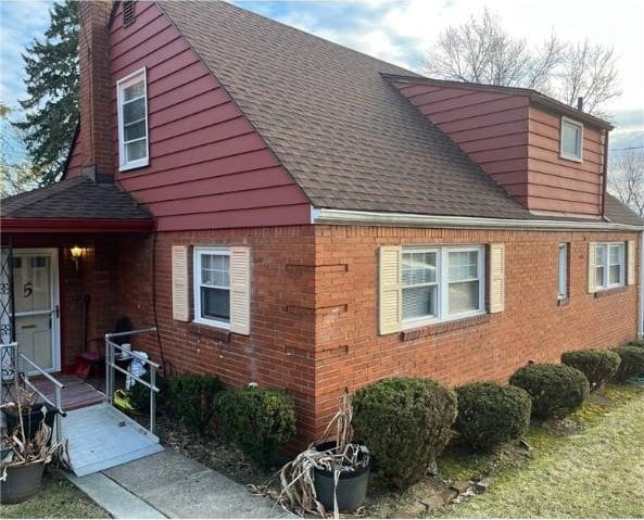 5 Barton Dr, Churchill Boro, PA 15221 - view of side of property featuring brick siding, a shingled roof, and a chimney