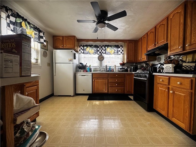 5 Barton Dr, Churchill Boro, PA 15221 - kitchen with white appliances, under cabinet range hood, a ceiling fan, light floors, and brown cabinetry