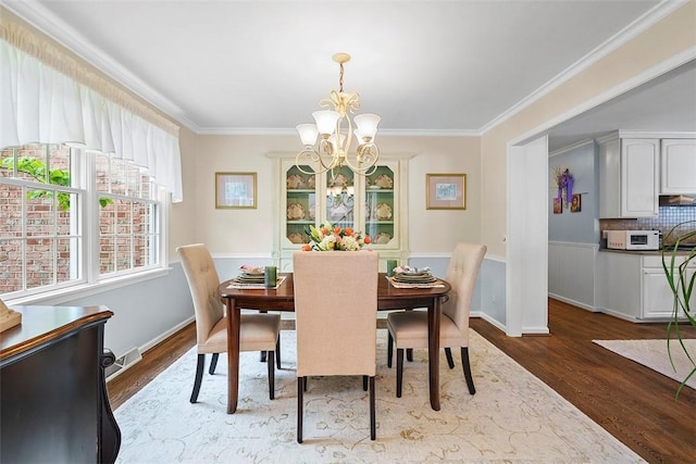 1544 Eldorado Dr, Hopewell Twp Bea, PA 15001 - dining area featuring a chandelier, wood finished floors, and ornamental molding