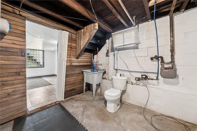 507 Sells Ln, Hempfield Twp Wml, PA 15601 - bathroom featuring unfinished concrete flooring, toilet, and wooden walls