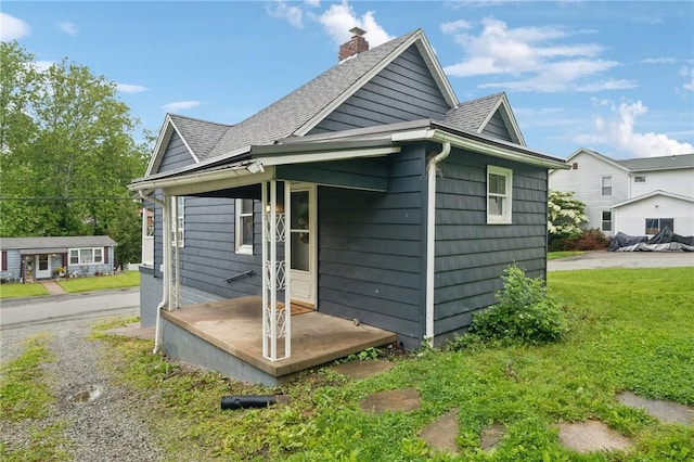 507 Sells Ln, Hempfield Twp Wml, PA 15601 - view of side of property featuring a shingled roof and a chimney