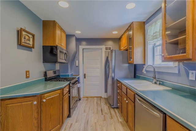 136 E Crafton Ave, Crafton, PA 15205 - kitchen with stainless steel appliances, a sink, brown cabinetry, light wood-style flooring, and recessed lighting