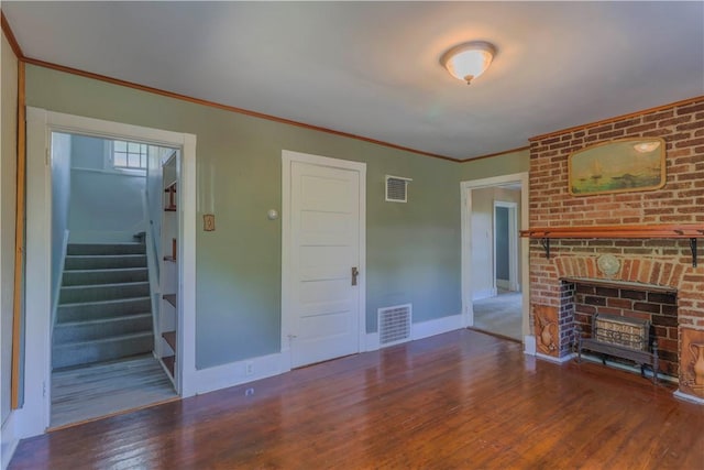 136 E Crafton Ave, Crafton, PA 15205 - unfurnished living room with wood finished floors, stairway, a brick fireplace, baseboards, and ornamental molding