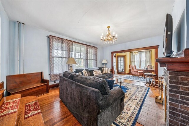 301 W Patriot St, Somerset Boro, PA 15501 - living area with a chandelier, a brick fireplace, and wood finished floors