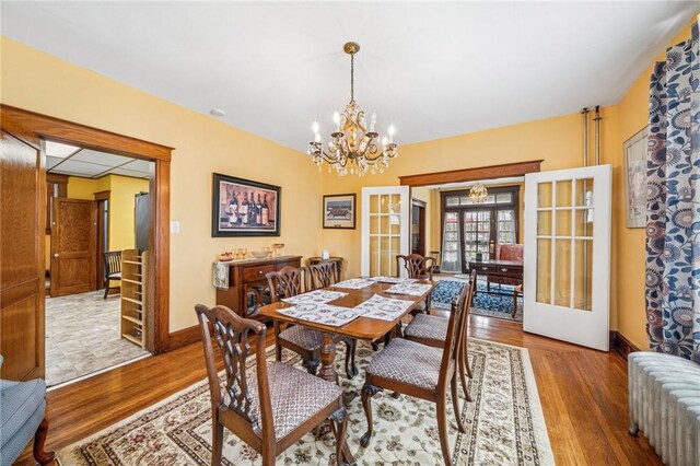 301 W Patriot St, Somerset Boro, PA 15501 - dining room featuring radiator, french doors, a chandelier, wood finished floors, and baseboards