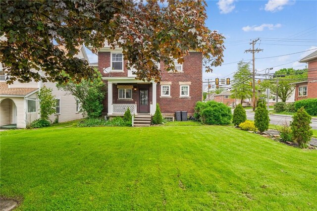 301 W Patriot St, Somerset Boro, PA 15501 - view of front facade featuring a front lawn, brick siding, and cooling unit