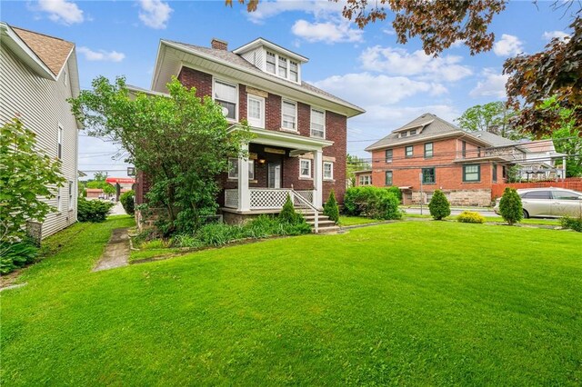 301 W Patriot St, Somerset Boro, PA 15501 - traditional style home featuring brick siding, a front lawn, a chimney, and a porch