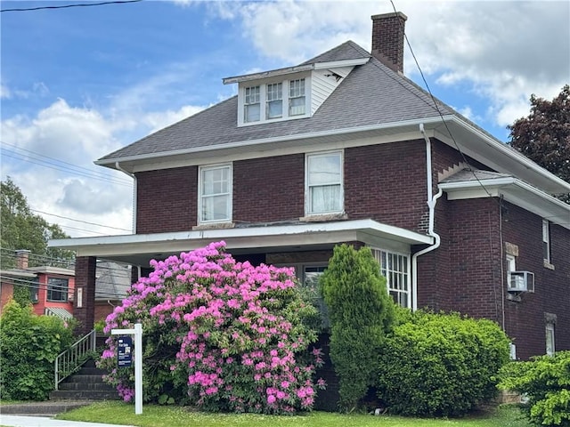 301 W Patriot St, Somerset Boro, PA 15501 - traditional style home with a chimney, brick siding, a porch, and a shingled roof