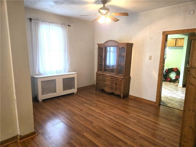 1505 Berkshire Ave, Brookline, PA 15226 - unfurnished bedroom featuring radiator heating unit, wood finished floors, baseboards, a textured ceiling, and ceiling fan