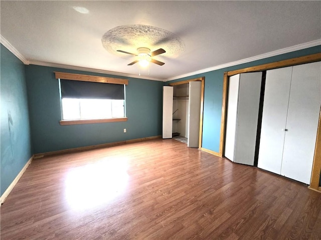1505 Berkshire Ave, Brookline, PA 15226 - unfurnished bedroom featuring multiple closets, crown molding, wood finished floors, baseboards, and ceiling fan