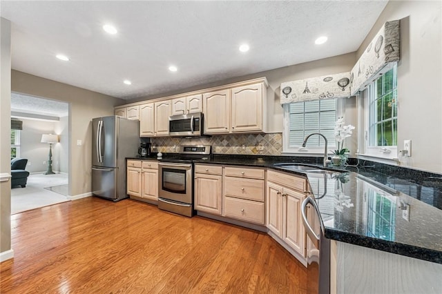 8201 Club Side Dr, Adams Twp, PA 16046 - kitchen with stainless steel appliances, a sink, light wood-style flooring, tasteful backsplash, and light brown cabinets