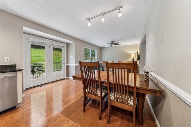 8201 Club Side Dr, Adams Twp, PA 16046 - dining space featuring a textured ceiling, a ceiling fan, light wood finished floors, and baseboards