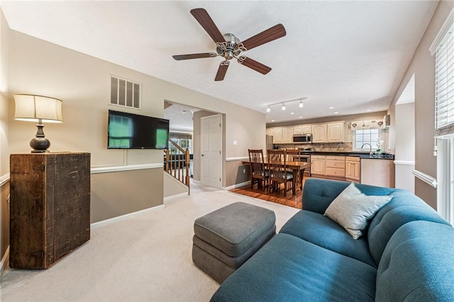 8201 Club Side Dr, Adams Twp, PA 16046 - living area featuring baseboards, stairway, a ceiling fan, and light colored carpet