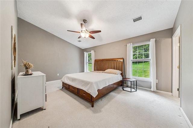 8201 Club Side Dr, Adams Twp, PA 16046 - bedroom with multiple windows, light carpet, baseboards, ceiling fan, and a textured ceiling