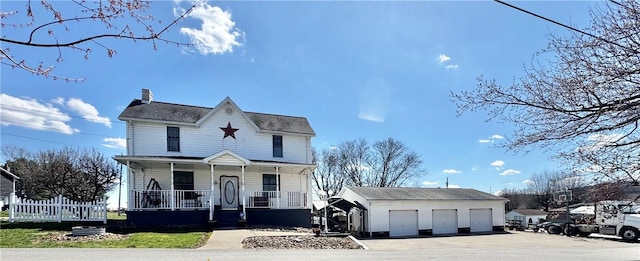 211 Stephens St, Vanderbilt, PA 15486 - view of front facade featuring a garage, covered porch, a chimney, and an outbuilding