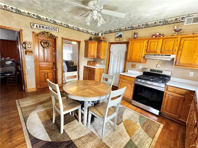 211 Stephens St, Vanderbilt, PA 15486 - kitchen with stainless steel gas range oven, under cabinet range hood, wood finished floors, and brown cabinets