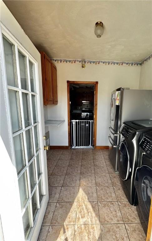 211 Stephens St, Vanderbilt, PA 15486 - laundry area with washer and clothes dryer, cabinet space, light tile patterned floors, and baseboards