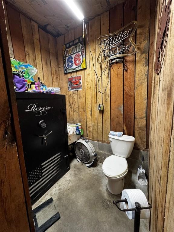 211 Stephens St, Vanderbilt, PA 15486 - bathroom featuring wood walls, unfinished concrete flooring, and toilet