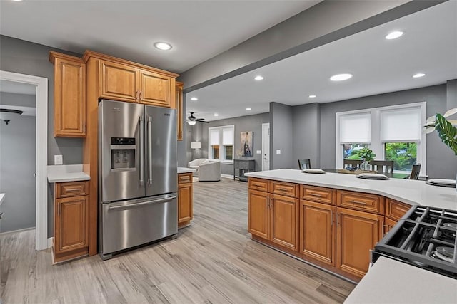 273 Inglewood Dr, Mt Lebanon, PA 15228 - kitchen with stainless steel fridge, brown cabinetry, light countertops, plenty of natural light, and recessed lighting