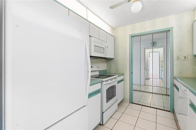 5600 Munhall Rd Unit 606, Squirrel Hill, PA 15217 - kitchen featuring white appliances, light tile patterned floors, a ceiling fan, white cabinets, and light countertops