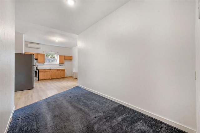 636 Edmond St, Bloomfield, PA 15224 - unfurnished living room with a wall mounted air conditioner, baseboards, a sink, and light colored carpet