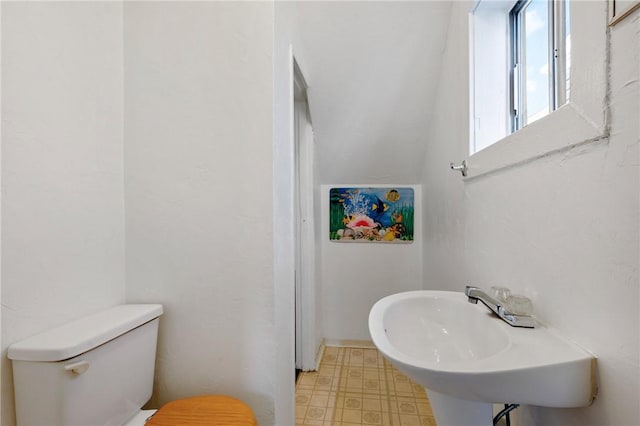 636 Edmond St, Bloomfield, PA 15224 - half bathroom featuring toilet, tile patterned floors, and a sink