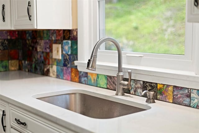 108 W Rd, Shaler, PA 15209 - kitchen view of a sink, white cabinetry, light countertops, and decorative backsplash