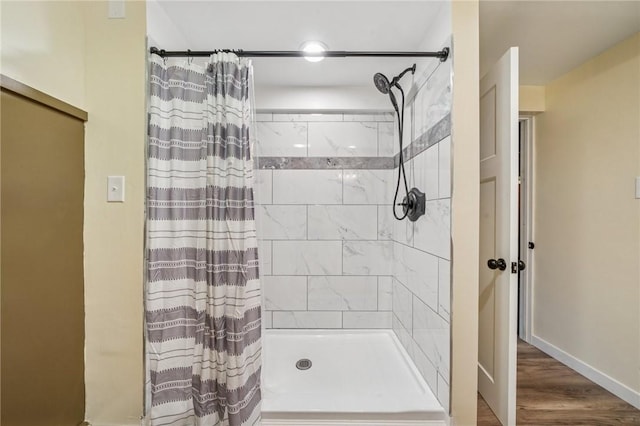 1507 Woodlawn Dr, Unity Twp, PA 15650 - full bath with tiled shower, wood finished floors, and baseboards