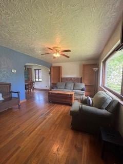 798 Hecla Rd, Mount Pleasant Twp Wml, PA 15666 - living area featuring a textured ceiling, arched walkways, wood finished floors, and a ceiling fan