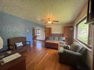 798 Hecla Rd, Mount Pleasant Twp Wml, PA 15666 - living room featuring arched walkways, a textured ceiling, wood finished floors, and ceiling fan