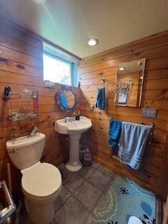 798 Hecla Rd, Mount Pleasant Twp Wml, PA 15666 - half bathroom with wooden walls, toilet, and tile patterned flooring