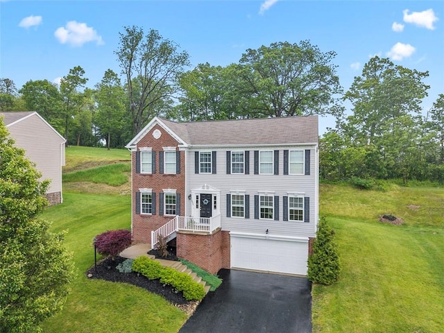 1033 Granite Dr, South Fayette, PA 15057 - view of front of house featuring brick siding, asphalt driveway, an attached garage, and a front yard