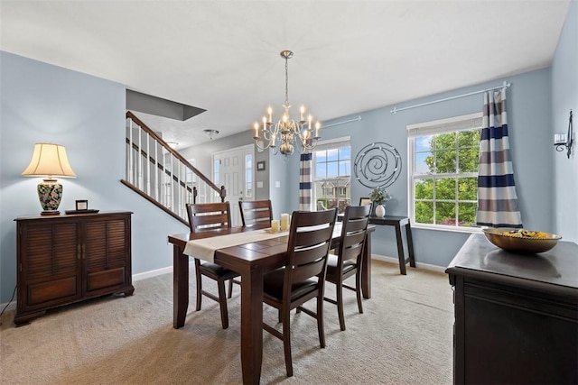 1033 Granite Dr, South Fayette, PA 15057 - dining space with a chandelier, light colored carpet, baseboards, and stairway