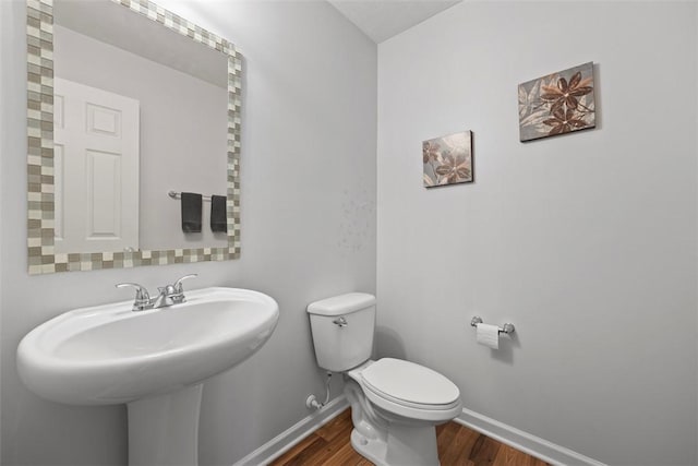 1033 Granite Dr, South Fayette, PA 15057 - bathroom with baseboards, wood finished floors, toilet, and a sink
