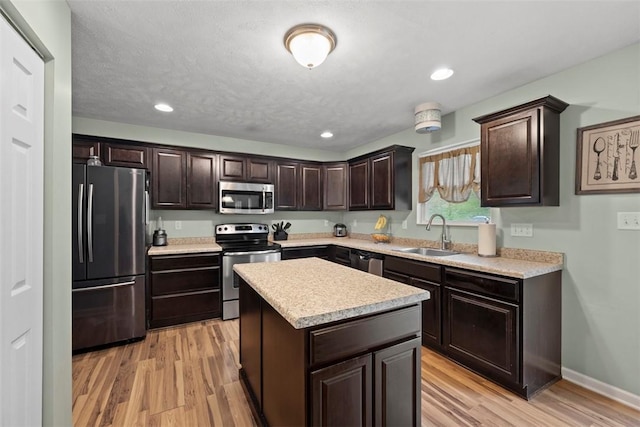 1033 Granite Dr, South Fayette, PA 15057 - kitchen with stainless steel appliances, a sink, dark brown cabinets, light countertops, and recessed lighting