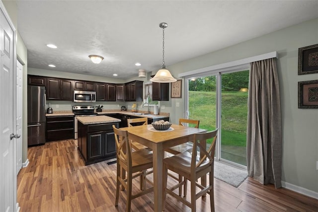 1033 Granite Dr, South Fayette, PA 15057 - kitchen with stainless steel appliances, light countertops, light wood finished floors, recessed lighting, and a kitchen island