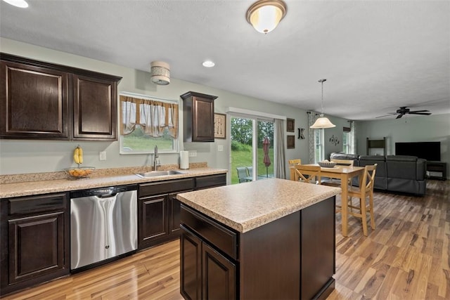 1033 Granite Dr, South Fayette, PA 15057 - kitchen featuring stainless steel dishwasher, a sink, dark brown cabinets, light wood-style floors, and light countertops