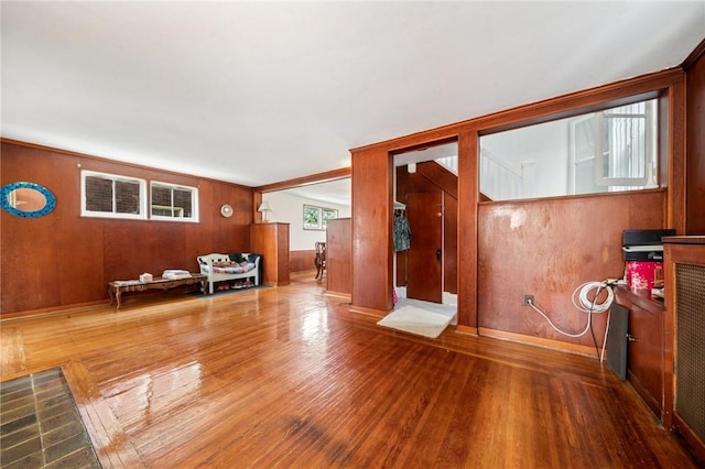 7333 Mcclure Ave, Swissvale, PA 15218 - unfurnished living room featuring wood finished floors and wood walls