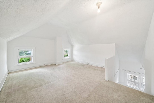 7333 Mcclure Ave, Swissvale, PA 15218 - additional living space featuring carpet floors, vaulted ceiling, a textured ceiling, and baseboards