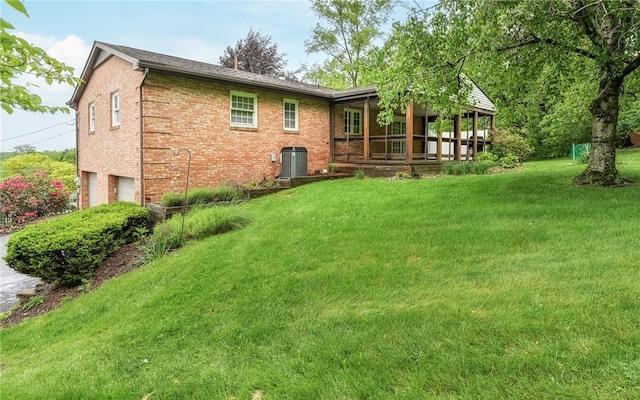 4610 School Dr, Hampton, PA 15101 - back of house featuring an attached garage, brick siding, a yard, and cooling unit