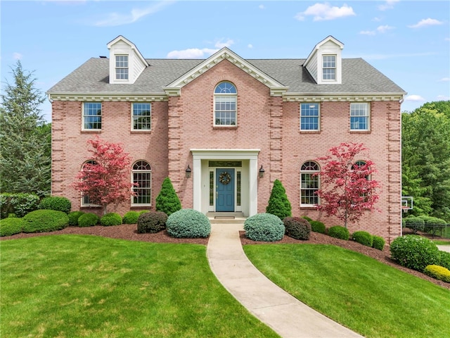 105 Pin Oak Ct, Peters Twp, PA 15367 - colonial inspired home featuring brick siding, a front lawn, and roof with shingles