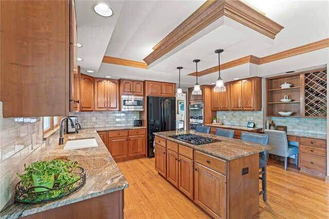105 Pin Oak Ct, Peters Twp, PA 15367 - kitchen featuring a sink, stainless steel microwave, freestanding refrigerator, ornamental molding, and light stone countertops