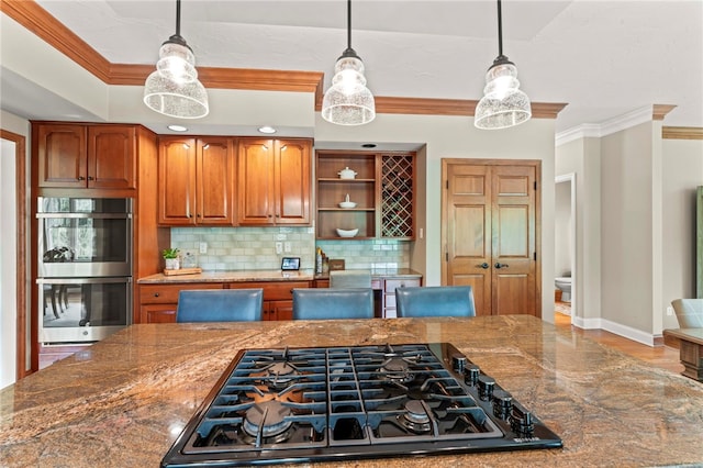 105 Pin Oak Ct, Peters Twp, PA 15367 - kitchen with stainless steel double oven, black gas stovetop, ornamental molding, tasteful backsplash, and decorative light fixtures