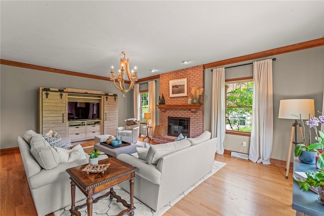 105 Pin Oak Ct, Peters Twp, PA 15367 - living room featuring a chandelier, light wood-style floors, baseboards, a fireplace, and crown molding