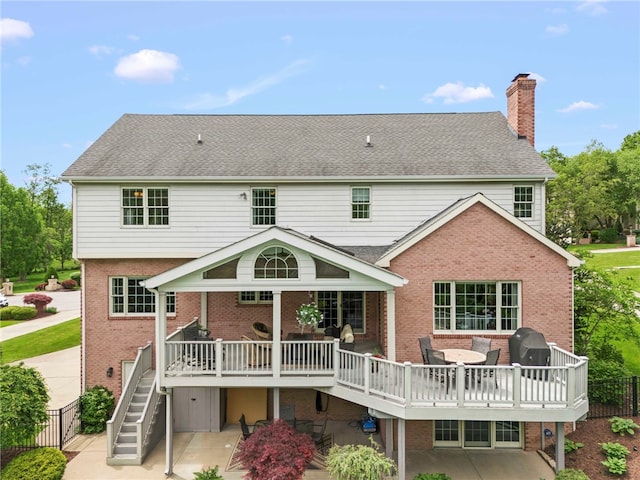 105 Pin Oak Ct, Peters Twp, PA 15367 - back of property with brick siding, a chimney, and a deck