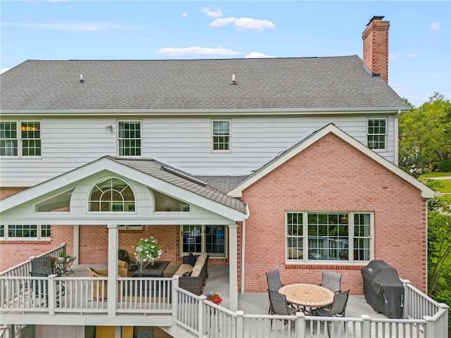 105 Pin Oak Ct, Peters Twp, PA 15367 - rear view of property featuring outdoor dining area, brick siding, and a chimney