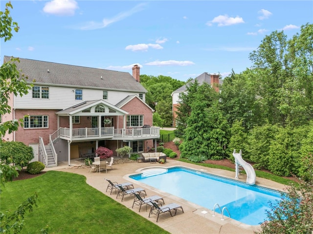 105 Pin Oak Ct, Peters Twp, PA 15367 - rear view of property featuring stairs, brick siding, a lawn, a patio area, and a wooden deck
